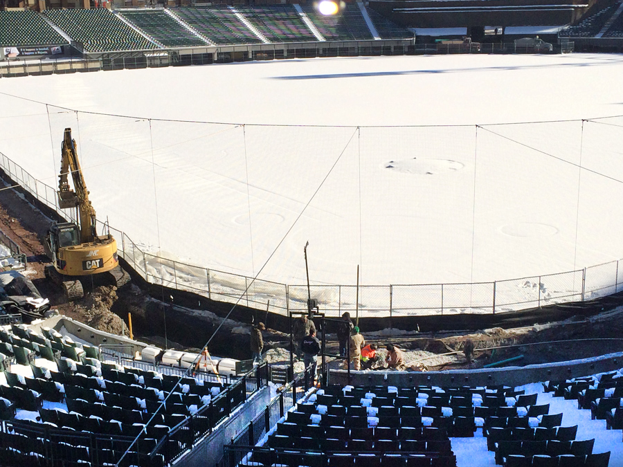 US-Cellular-IMG_2038_web Excavation work in a baseball stadium during winter, with heavy machinery and workers preparing the field area.