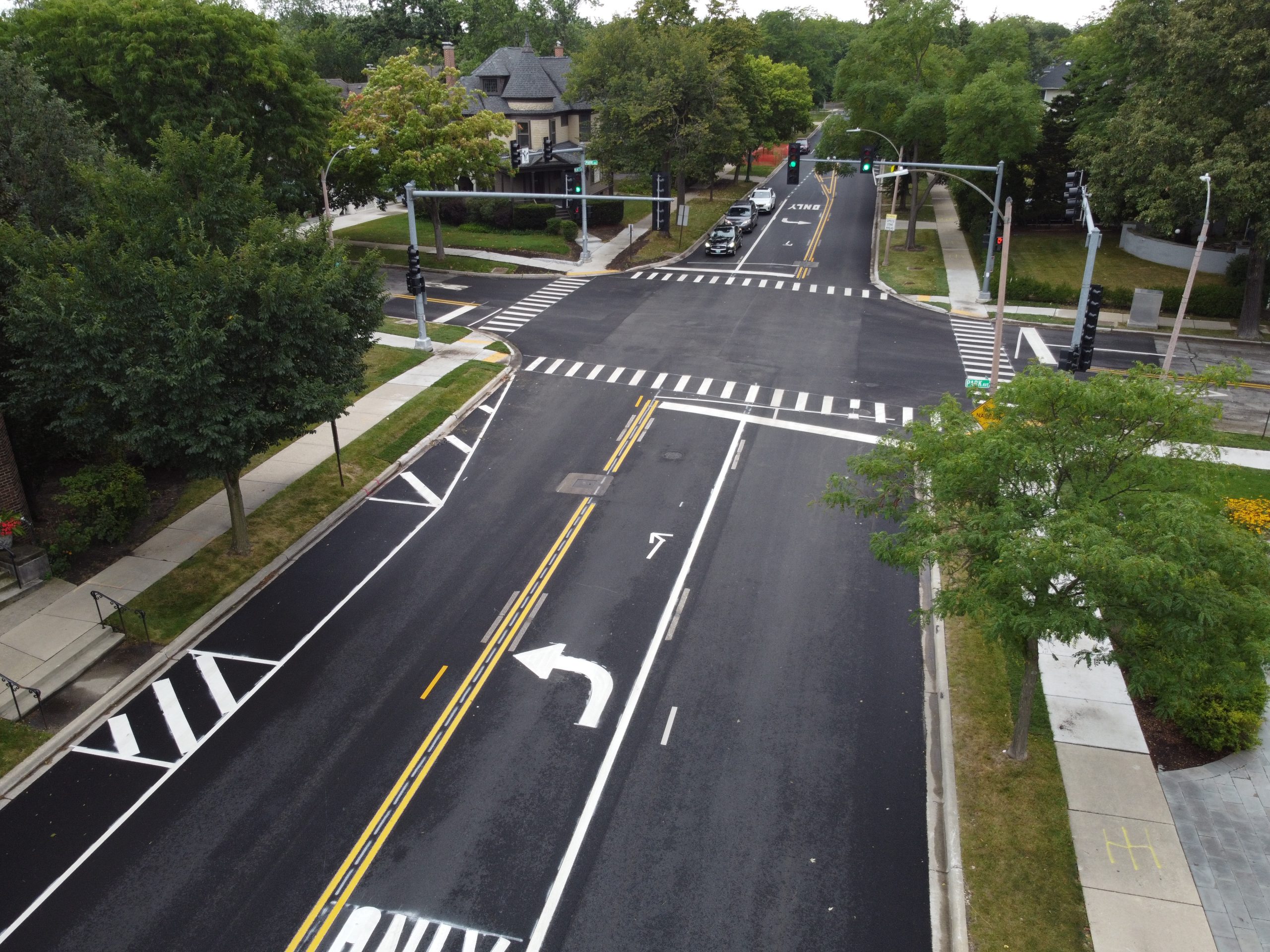 DCIM101MEDIADJI_0668.JPG Aerial view of a newly paved intersection featuring traffic lights, crosswalks, and landscaping along the sides.